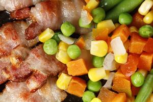 Vegetables with bacon. Tasty and simple food. Traditional lunch. photo