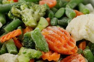 Frozen vegetables close-up. Vegetables in the fridge photo