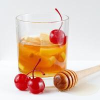 Lemon cocktail with cherry, honey and ice. photo