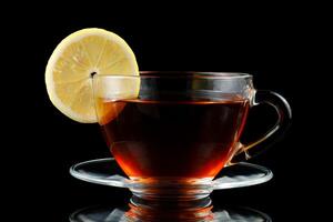 Tea with lemon in a cup. Hot tea with a lemon photo