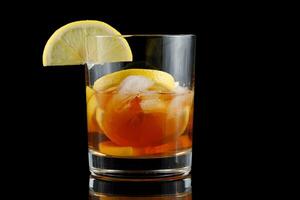 Tea with lemon in a glass. iced tea with fresh cherries and lemons photo