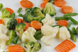 Frozen vegetables close-up on a white background. photo