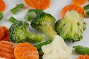 Frozen vegetables close-up on a white background. photo