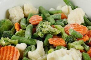 Frozen vegetables close-up. Vegetables in the fridge photo