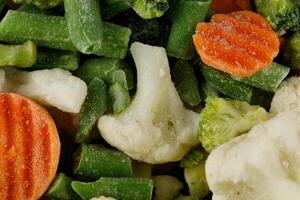 Frozen vegetables close-up. Heap of frozen vegetable mix photo