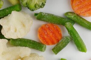 Frozen vegetables close-up on a white background. photo