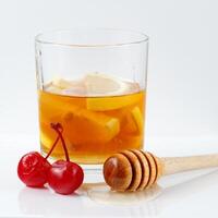 Lemon cocktail with cherry, honey and ice. Fresh colorful exotic alcoholic cocktail with lemon and ice photo
