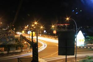 time lapse or long exposure photography of traffic on the street at night and railway train photo