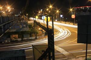 time lapse or long exposure photography of traffic on the street at night and railway train photo