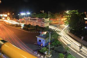 time lapse or long exposure photography of traffic on the street at night and railway train photo