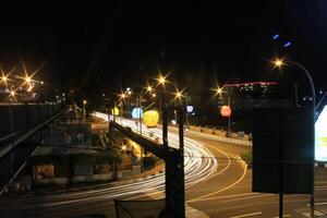 time lapse or long exposure photography of traffic on the street at night and railway train photo