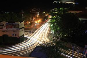 time lapse or long exposure photography of traffic on the street at night and railway train photo