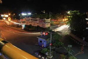 time lapse or long exposure photography of traffic on the street at night and railway train photo