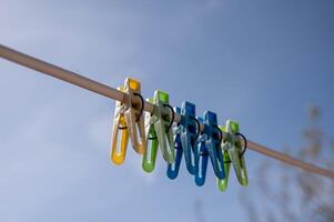 clothespins on a clothesline against the blue sky in spring photo
