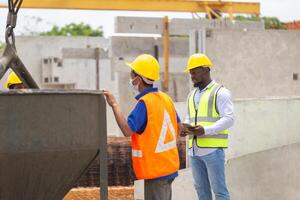 Construction workers at work, Foreman and worker team discussing at precast concrete factory site photo