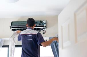 Technician man clean air conditioning system, Maintenance and service concepts photo