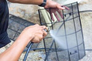 Repairman washed the dirty air conditioner filter, Technician cleaned mold in the air conditioning system, Maintenance and service concepts photo