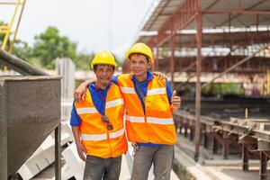 Portrait of factory worker man team in hard hat at the precast factory site, Workers man on construction site photo