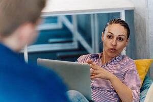 A modern programmer discussing future business projects with colleagues in a modern startup office photo