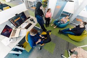 Top view photo of collaborative process of multicultural skilled young business team during brainstorming meeting in office.Diverse group of young people dressed in formal wear cooperating on