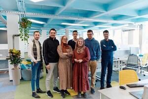 Portrait of a successful creative businessman and businesswoman looking at camera and smiling. Diverse business people standing together at startup. photo