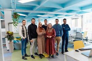 Portrait of a successful creative businessman and businesswoman looking at camera and smiling. Diverse business people standing together at startup. photo