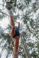 Adventurous Woman Overcoming Forest Obstacles with Determination and Agility. photo