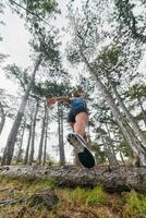 Adventurous Woman Overcoming Forest Obstacles with Determination and Agility. photo