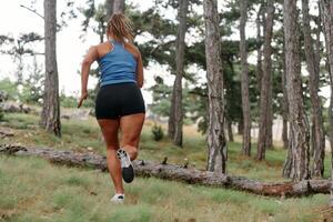 Fearless Woman Conquering Wooden Obstacles in the Dangerous Forest Terrain. photo