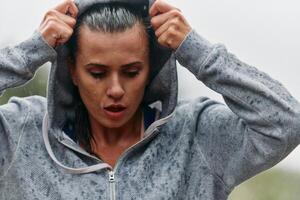 Woman Resting in the Rain After Intense Run photo