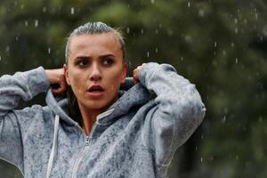 Woman Resting in the Rain After Intense Run photo