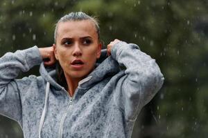 Woman Resting in the Rain After Intense Run photo