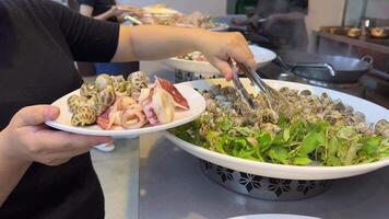 Taiwanese local seafood store with clam and squid. Squid shells with clam video