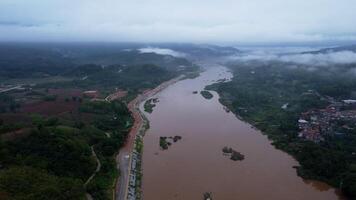 Aerial view of the mighty Mekong River winding from Chiang Khong, showing the vastness and beauty of the muddy waterway contrasting with the surrounding lush mountains and Laos villages. video
