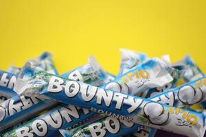 KYIV, UKRAINE - OCTOBER 31, 2023 Bounty chocolate bars with cocoa flavor filling. Bounty chocolate bar is a brand of American Mars Inc photo
