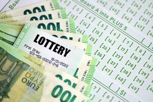 Green lottery tickets and euro money bills on blank with numbers for playing lottery photo