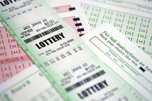 Green and red lottery tickets on blank bills with numbers for playing lottery photo