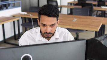 Indian business man trader investor analyst looking at financial stock market charts rate dynamic, trading data indexes growth using pc for cryptocurrency digital analytics video