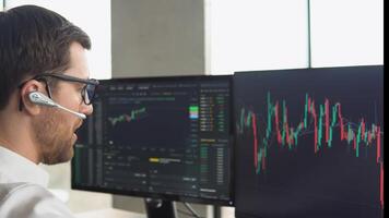 Successful trader is working with multiple computer screens full of charts and data analysis and stock broker trading online. Concept of bitcoin and stock market trading video
