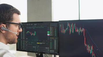 Successful trader is working with multiple computer screens full of charts and data analysis and stock broker trading online. Concept of bitcoin and stock market trading video