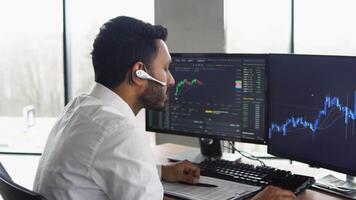 Indian trader broker checking stock trading data analysis concept working in office with financial graph video