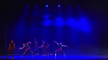 Silhouette of a dancer on stage with dramatic blue lighting and shadows, artistic performance concept. video