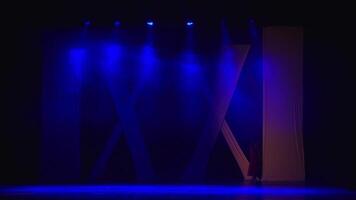 Empty stage with dramatic blue and purple lighting and smoke effects, creating a mysterious atmosphere. video