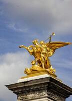 Golden Statue of a Woman Riding a Horse on the Alexander III Bridge in Paris photo