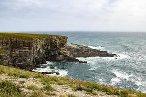 Dramatic Cliffs and Crashing Waves Along the Irish Coastline photo