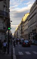 Traffic Light Green On Busy Parisian Street During Golden Hour photo