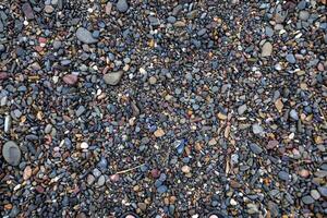 A Close Up View Of Colorful Pebbles On A Beach photo