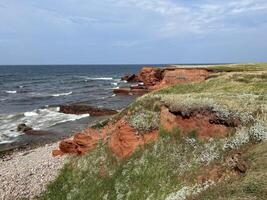 Red Cliffs on the Magdalen Islands, Quebec, Canada On A Sunny Summer Day photo