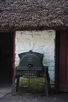 Leader Patent Agitator Outside of a Thatched Cottage in Ireland photo