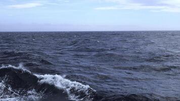 Waves from floating sea vessel. Clip. Beautiful moving waves from floating ship at sea. Beautiful sea horizon with moving waves from ship photo